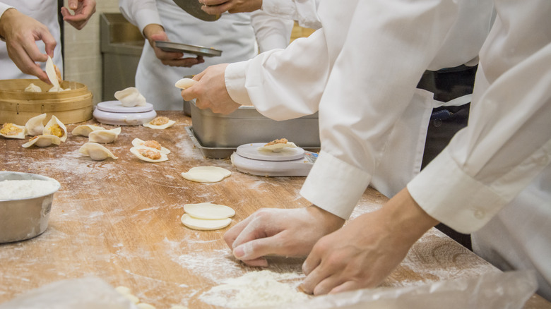 chefs making dumplings