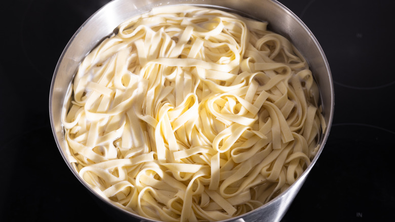 cooked tagliatelle pasta in pot