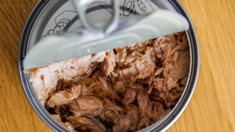 canned tuna on a wood table