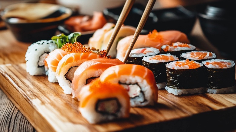 Salmon sushi on a platter with chopsticks