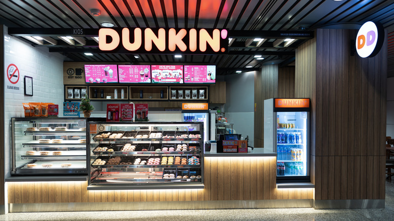 Dunkin' with glass case of donuts