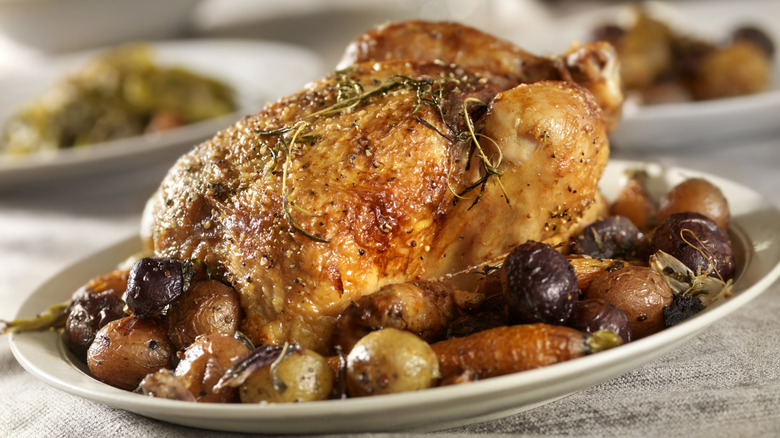 Roast chicken and potatoes on serving platter