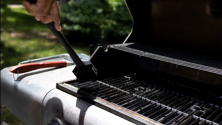 Hand scrubbing an outdoor grill