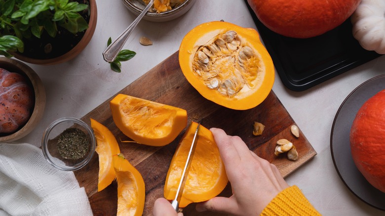 Person cooking with fresh pumpkin