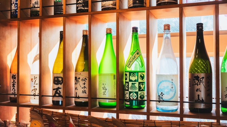 Sake bottles on wood shelves