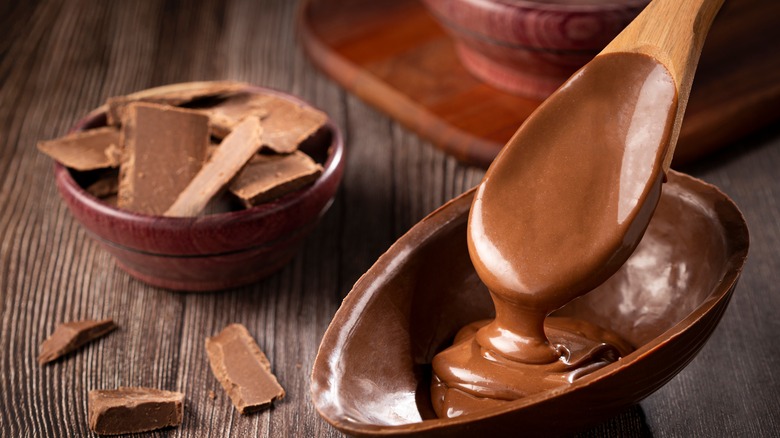 wooden spoon dipping into ganache