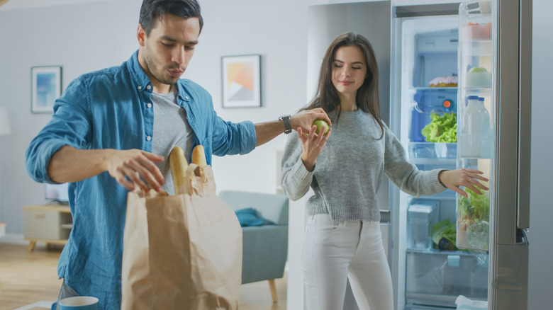 Couple unpacks groceries