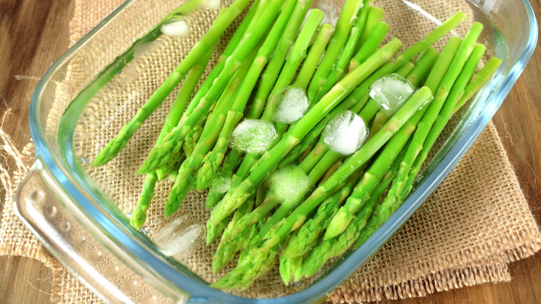 asparagus spears in an ice bath