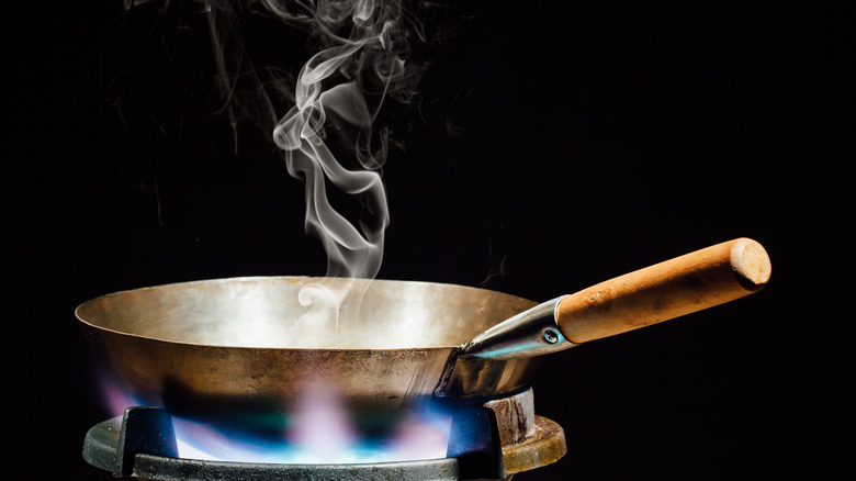 Smoke comes from a wok