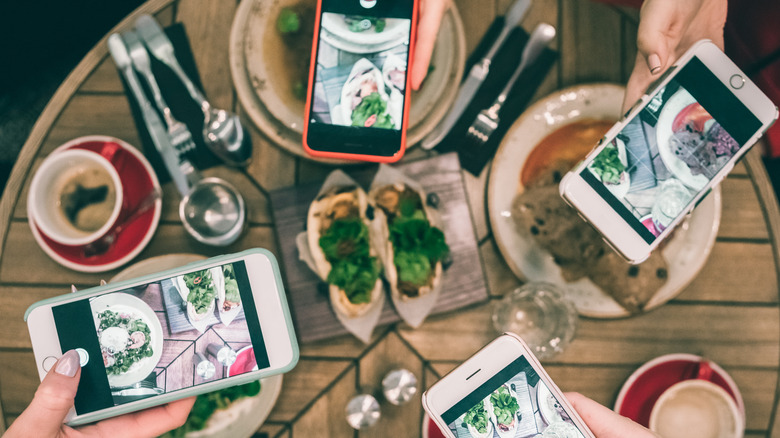 group taking photos of food