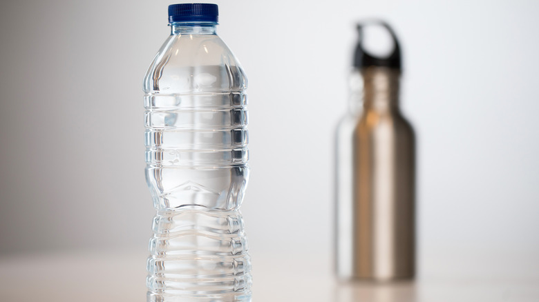 Plastic bottle foreground, metal bottle background