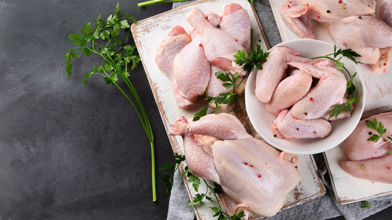 various cuts of raw chicken on trays