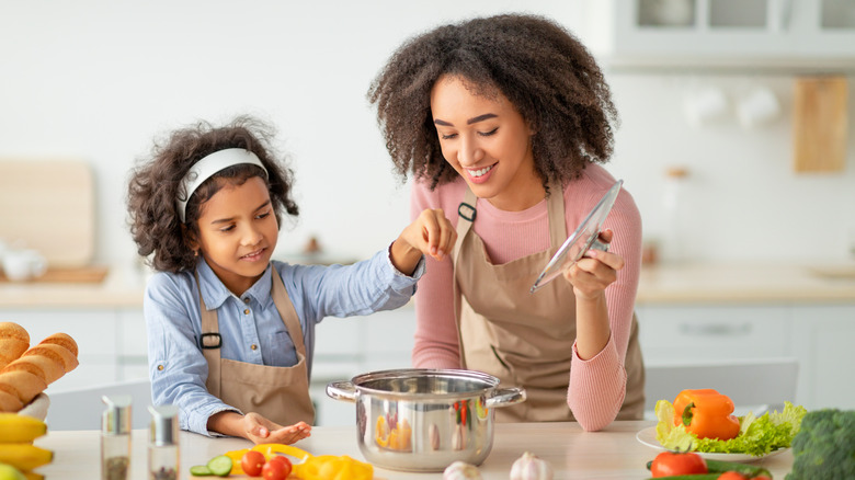 Sisters adding flavors to soup