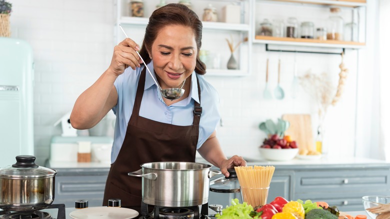 Woman tasting noodle soup