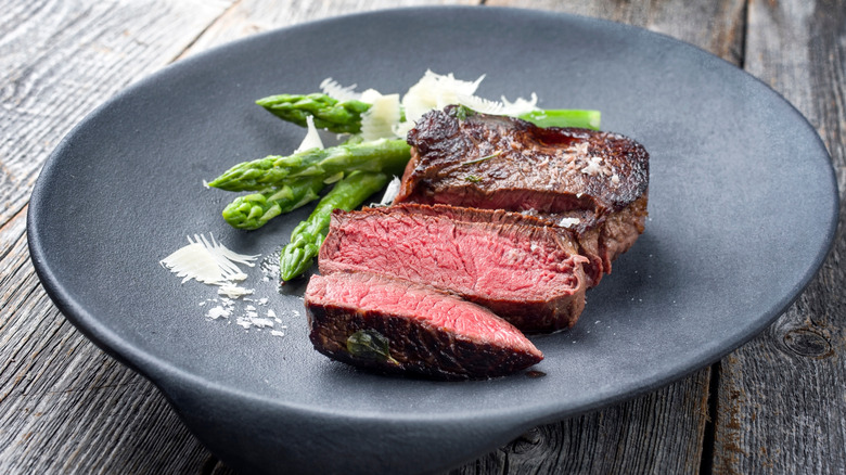 cast iron pan with butter and steak