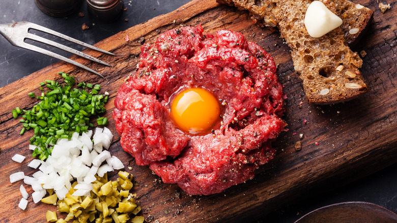 Steak tartare next to ingredients