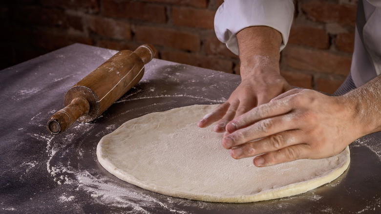 chef preparing pizza dough