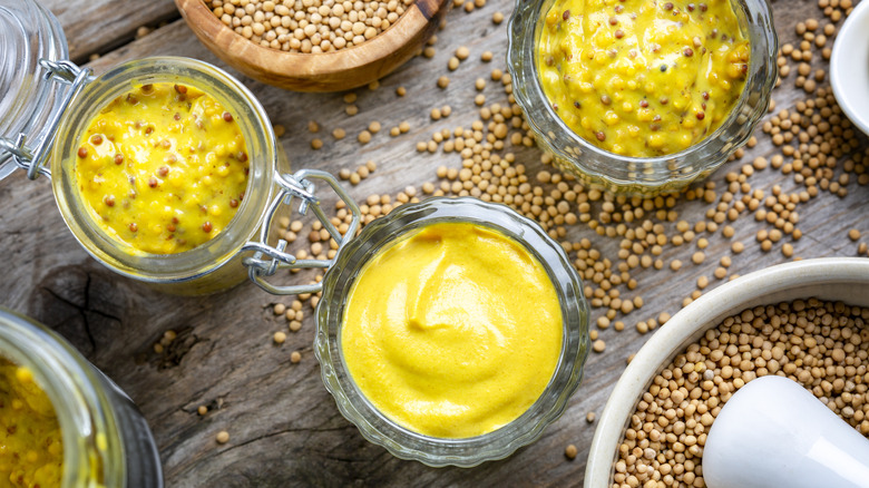 selection of mustards on wooden board