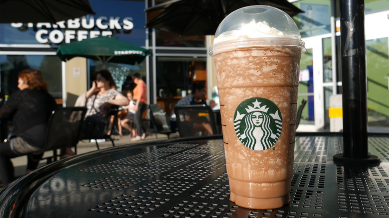 Starbucks venti mocha frappuccino on outside table