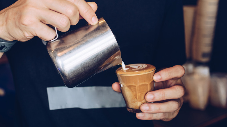 Barista pouring latte art for piccolo