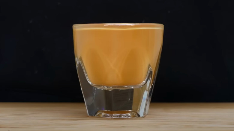 A cortado in a shot glass