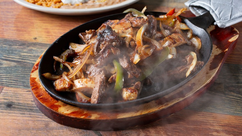 Sizzling platter of steak fajitas