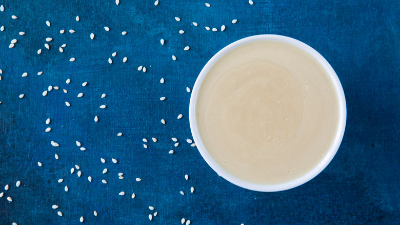 tahini in bowl on blue background