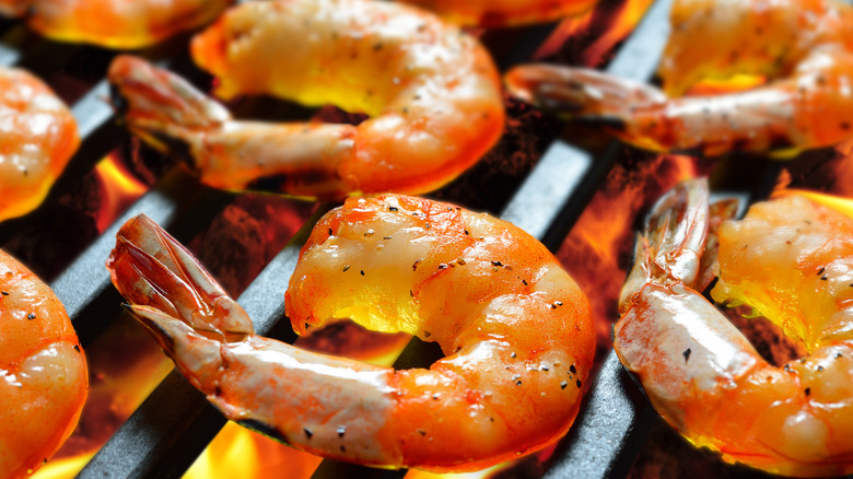 Shell-on shrimp cooking on the grill