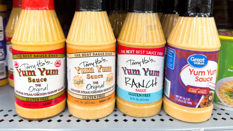 Grocery store dispaly of Terry Ho's and Wamart brand bottled yum yum sauces