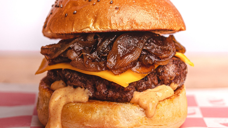 close up of cheese burger with caramelized onions