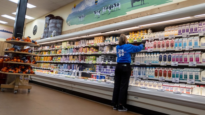 Trader Joe's employee stocking shelf