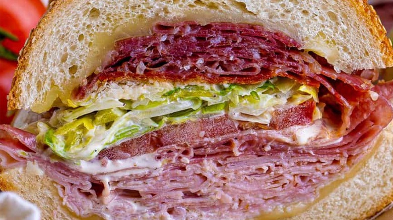 Close-up of sliced grinder sandwich with meats and lettuce