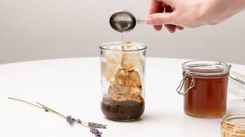 pouring syrup into iced latte