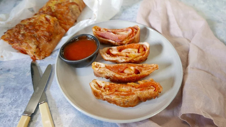 sliced pepperoni stromboli with sauce