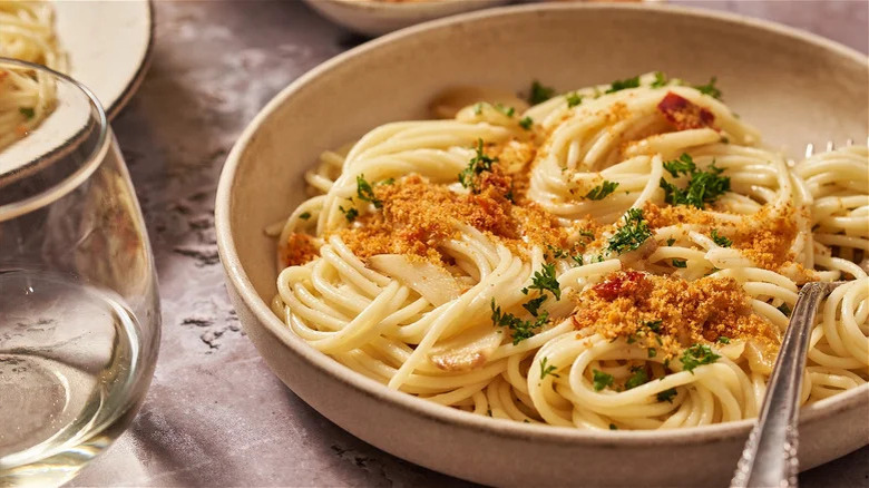 spaghetti in bowl with breadcrumbs