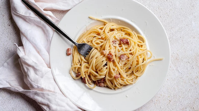 fork twirling spaghetti in bowl