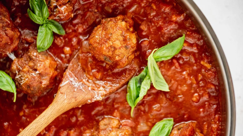 spoon with meatballs in sauce