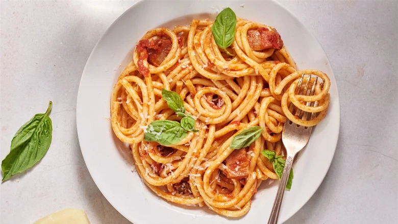 bucatini pasta on plate