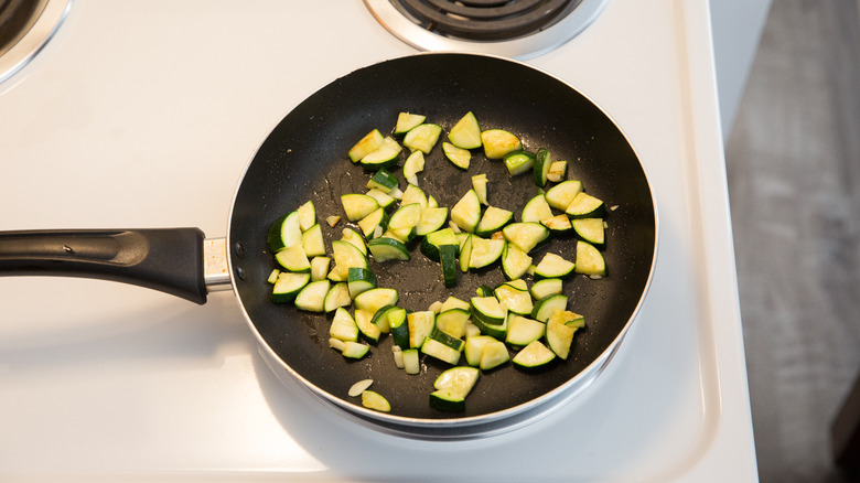 zucchini cooking in frying pan