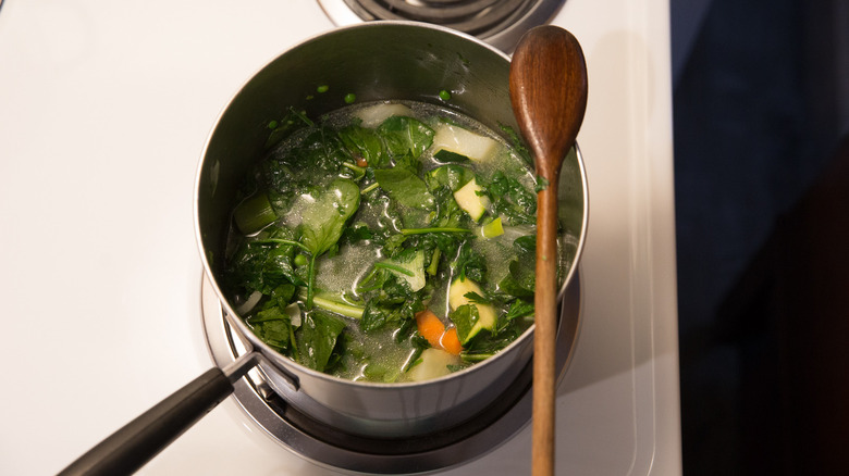 green soup simmering on stove