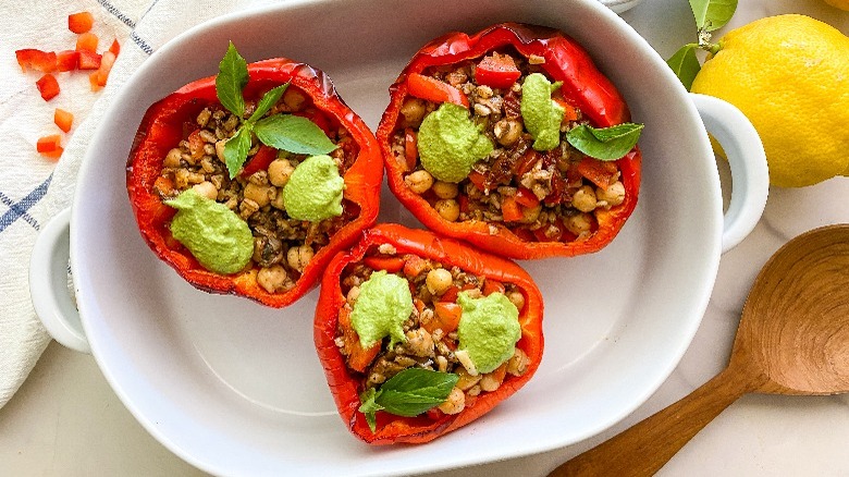 3 stuffed peppers in white oval dish