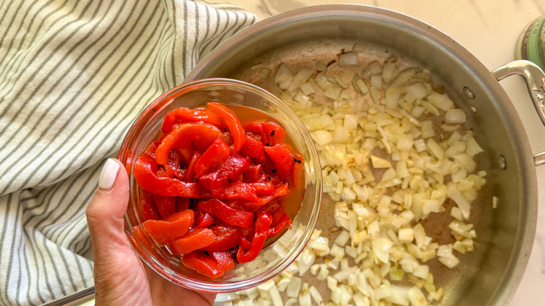 hand adding red pepper