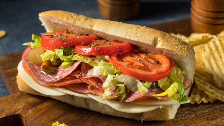 An Italian sub sandwich on a wooden board