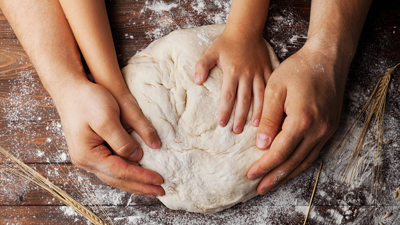 hands shaping dough