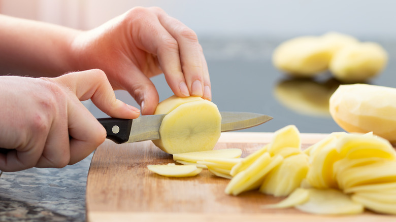 Person slicing potatoes