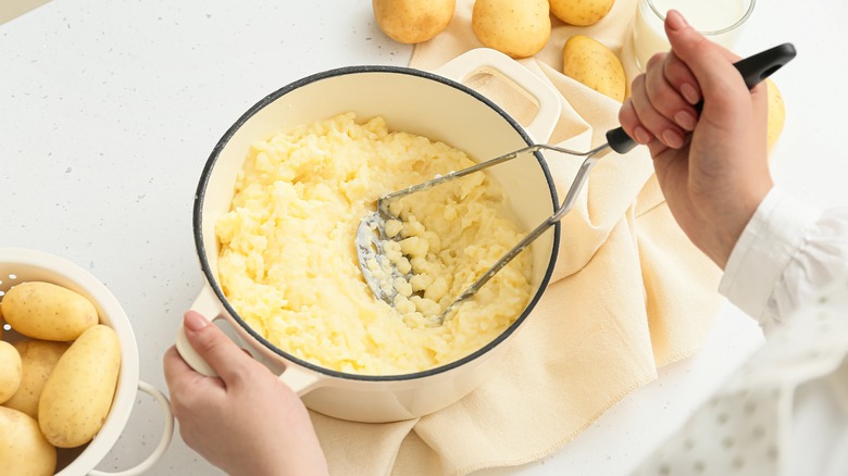 woman mashing potatoes