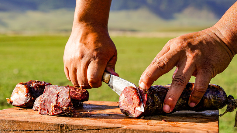 Horse sausage being sliced