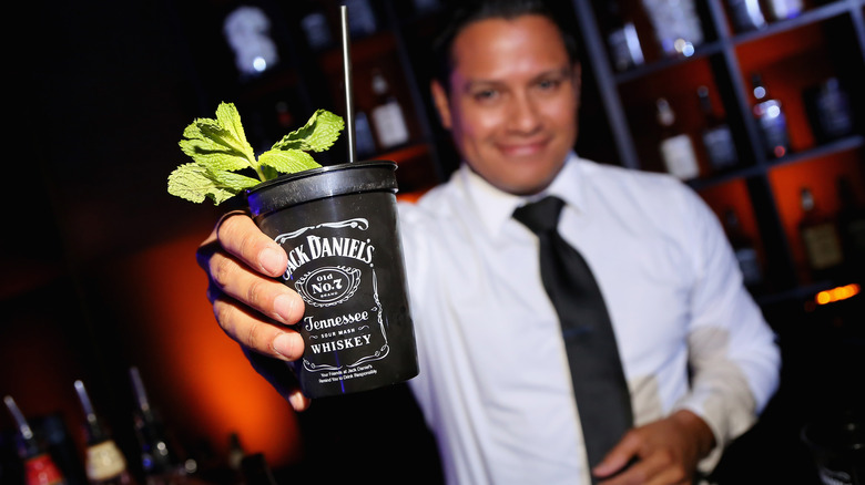Bartender holding Jack Daniel's cup
