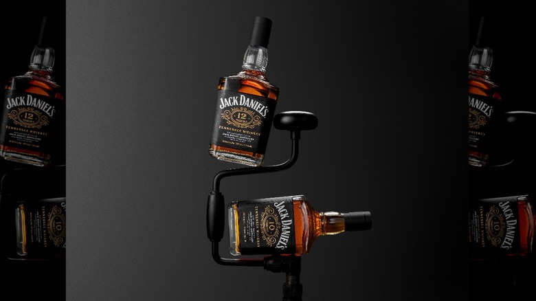 Jack Daniels bottles balanced on stand