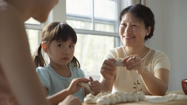 adult and child cooking together